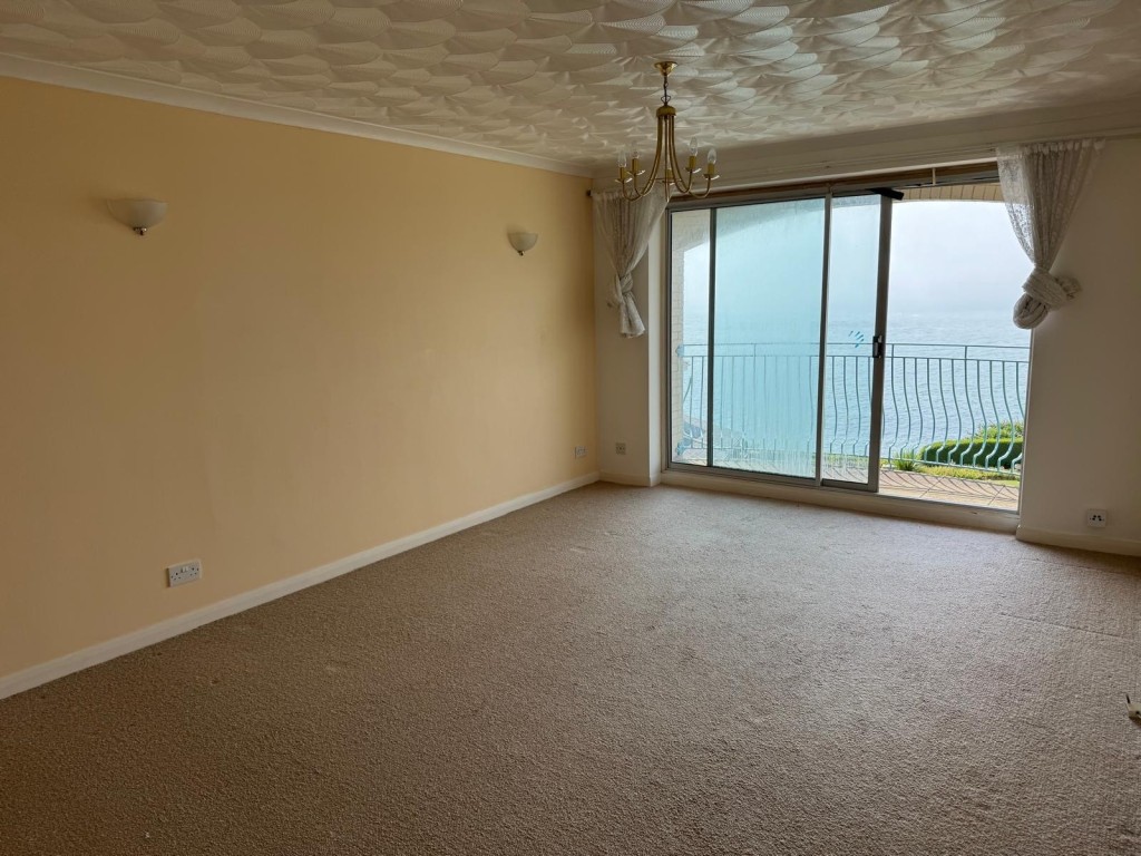 Lot: 73 - TWO-BEDROOM FLAT WITH GARAGE, BALCONY AND SPLENDID SEA VIEW - The Living Room Looking Out Towards the Balcony